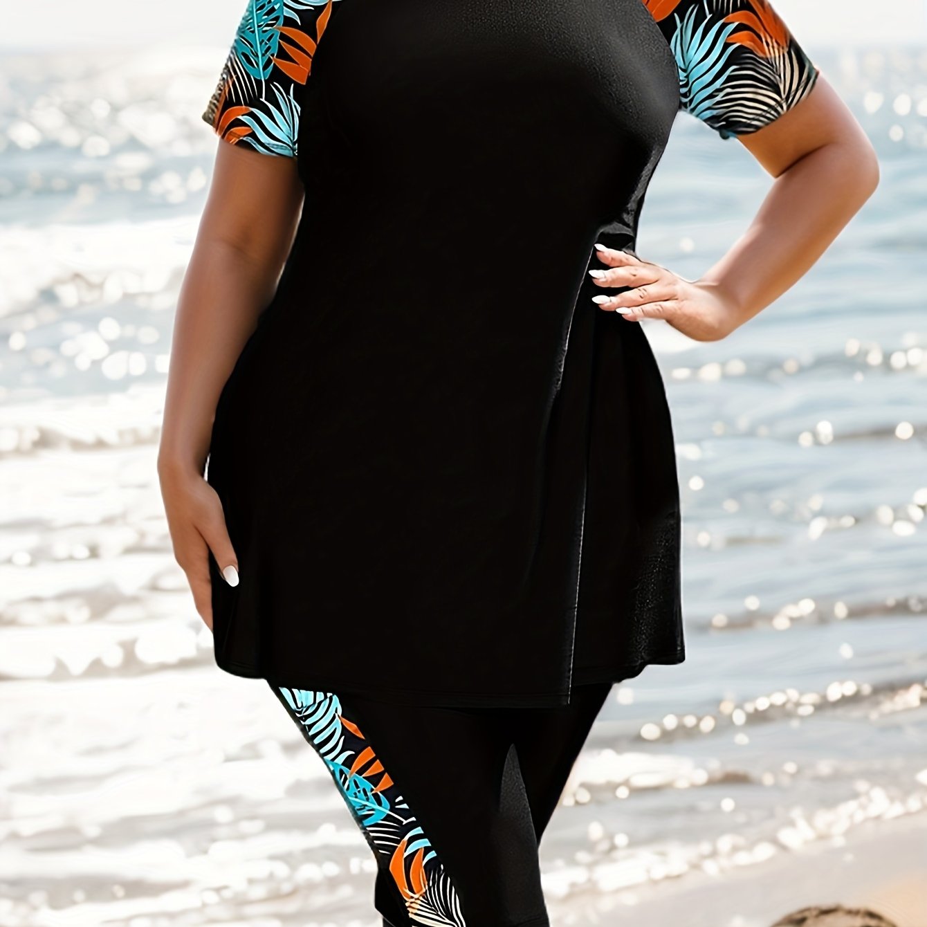 Tropical print swimsuit set for plus size women, made of stretchy polyester and elastane. Features round neck top with short sleeves and high-waist bottoms. Machine washable.