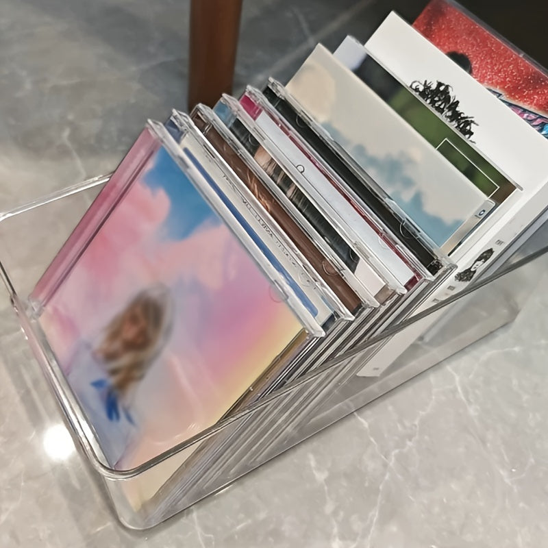 The Clear Acrylic CD/DVD Storage Basket is a sturdy and stylish solution for storing your media collection. This space-saving display rack can hold up to 20 standard cases, making it perfect for organizing your albums and games. Its durable construction