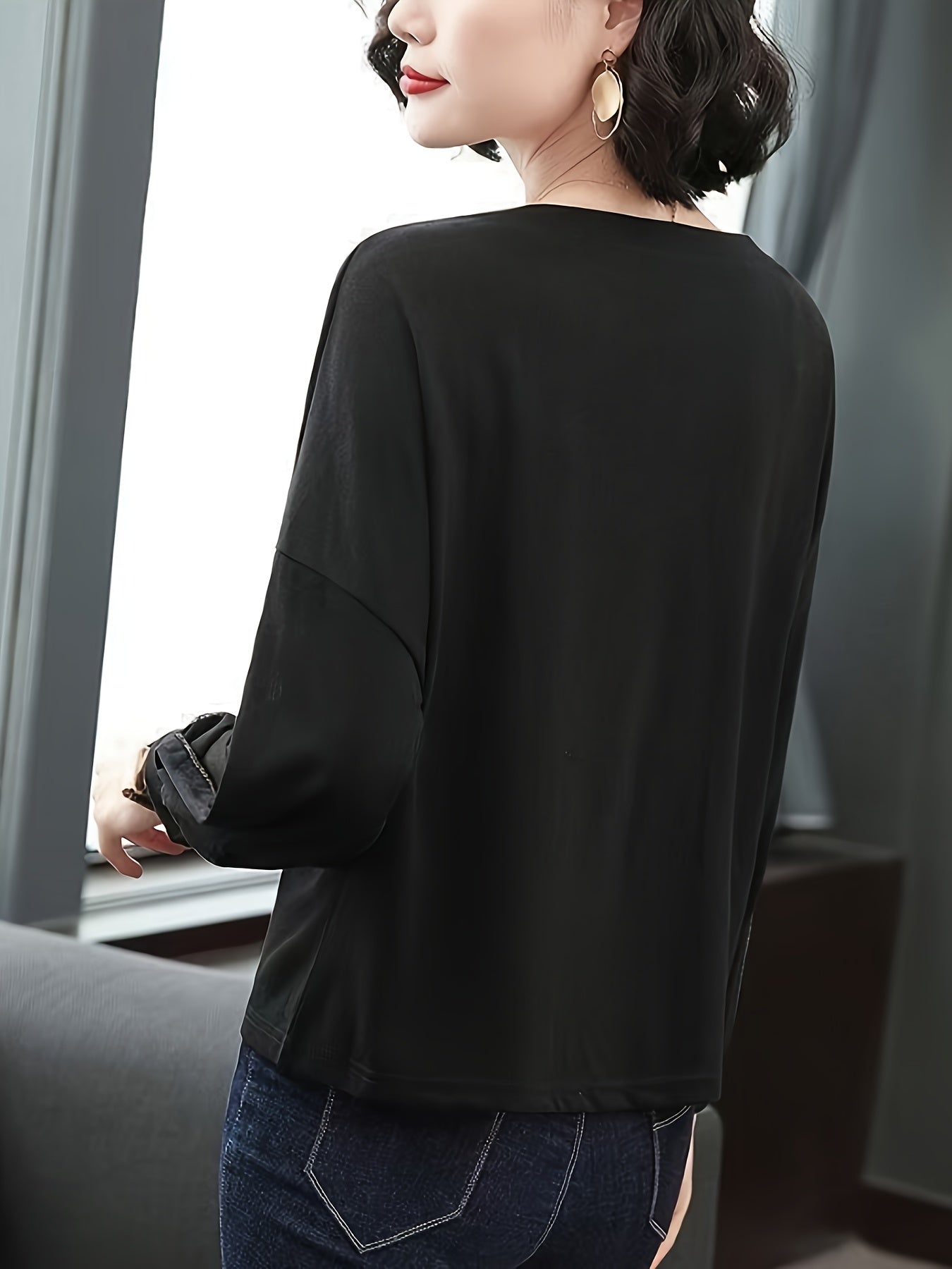 Women's rhinestone embellished loose-fit blouse with letter pattern design, made of polyester knit with mesh panels and a round neck for spring/autumn.