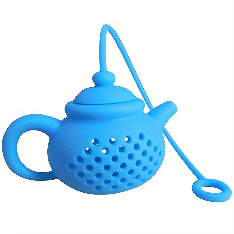 Reusable teapot-shaped tea infuser made of silicone for loose leaf tea, ideal for kitchen and dining use, small in size suitable for making tea.