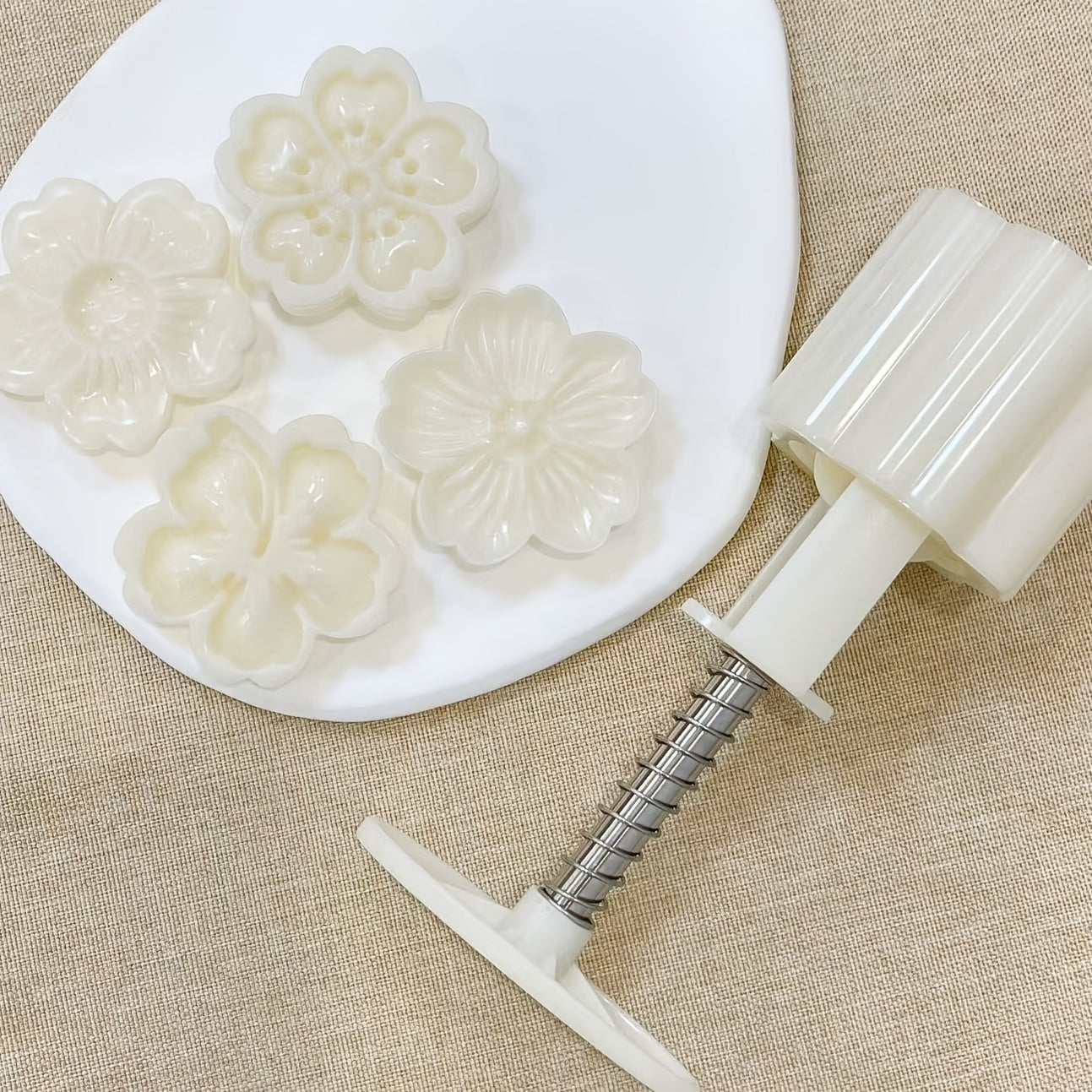 Set of 4 plastic mooncake embossing molds with blossom design for baking and crafting desserts.