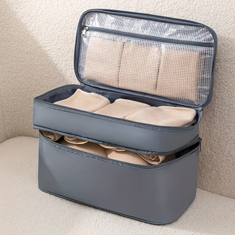 Travel underwear and bra organizer bag with double-layer design and divided compartments. Made of beige polyester fabric with a mesh interior. Ideal for dorms, trips, and daily use. Hand