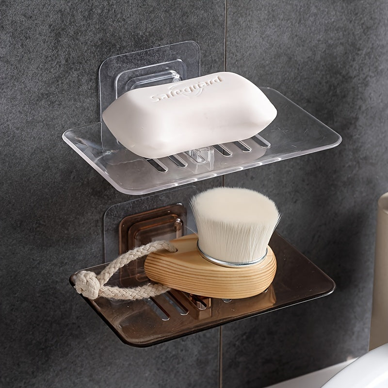 Wall-mounted soap dish with drainage, adhesive holder for bathroom organization.