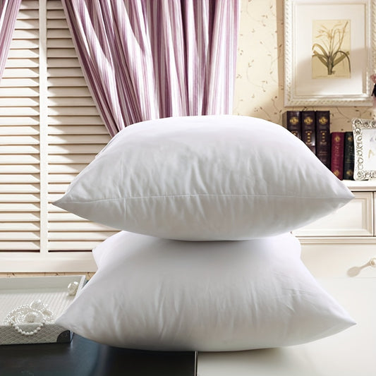 2 Soft white pillow inserts for Christmas decor in hotel or home.