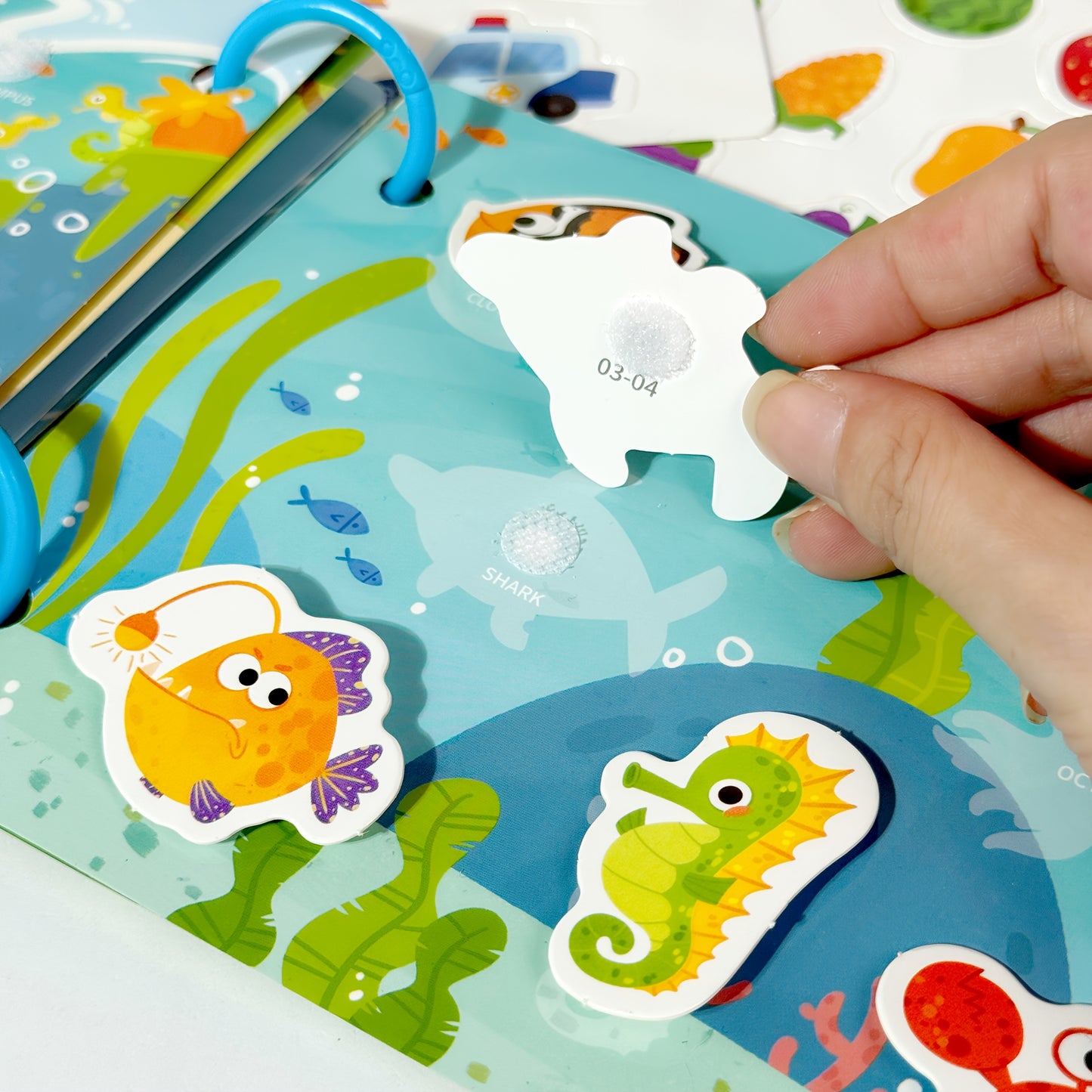 Reusable sticker book with quiet activities focusing on dinosaurs, fruits, animals, oceans, and transportation to improve cognitive, logical, and sensory skills through hands-on DIY tasks.