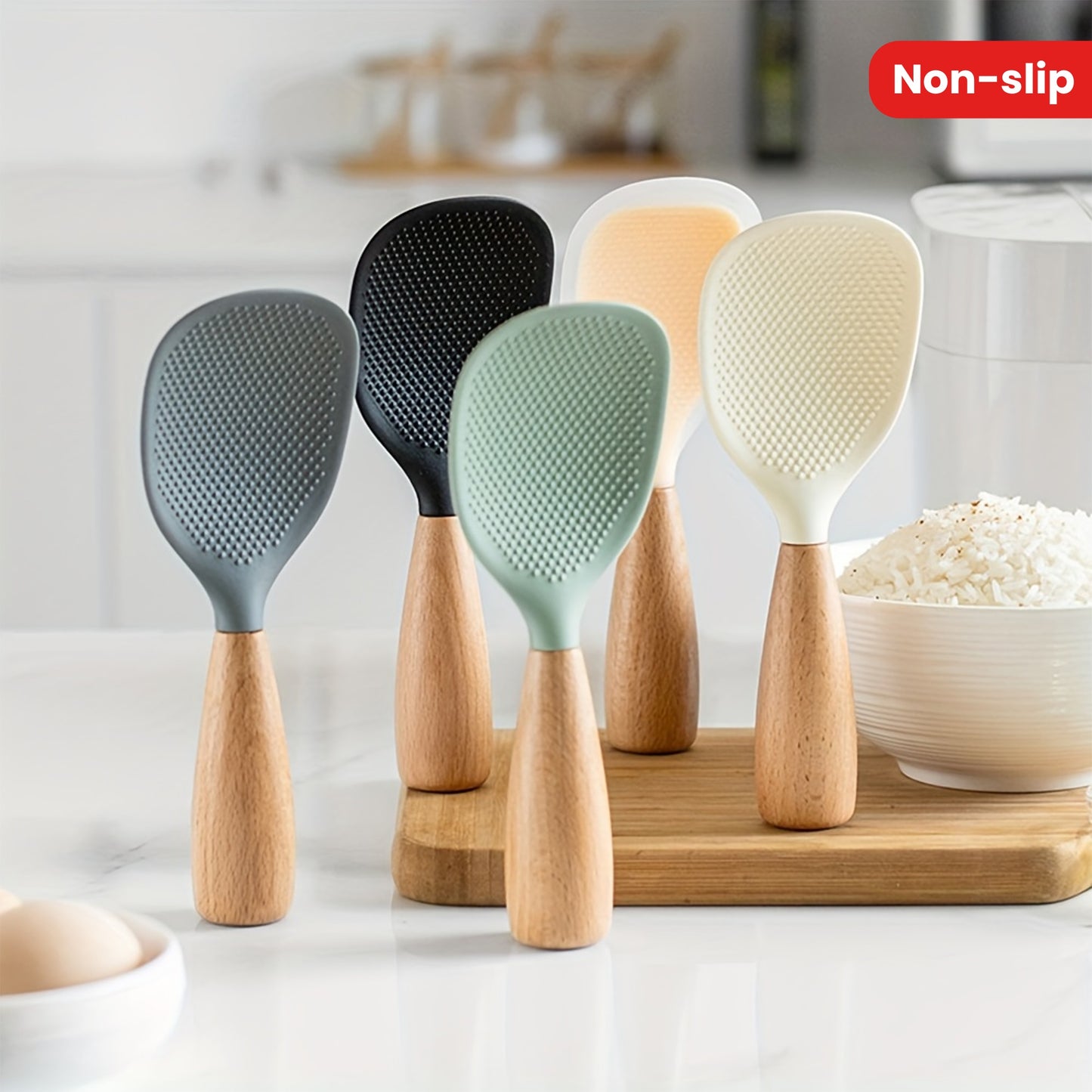 Heat resistant silicone spoon with wooden handle for non-slip rice cooker. Practical kitchen tool for home, school, and dorm.