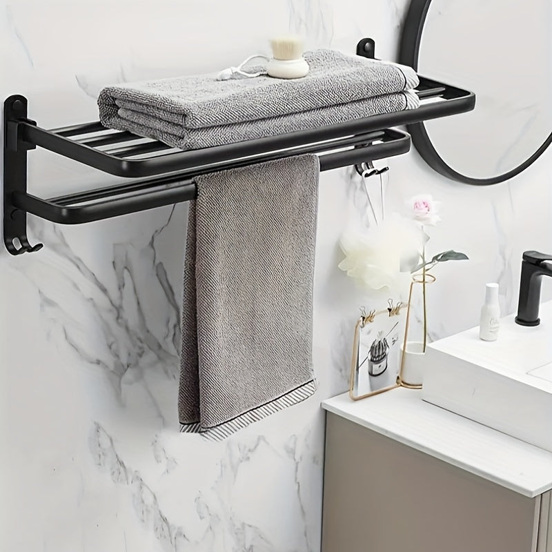 Compact black wall-mounted bathroom shelf with towel bar and hooks for convenient storage of towels, toiletries, and accessories. Easy to install with a sleek modern design and sturdy metal construction. Perfect towel holder for any bathroom.