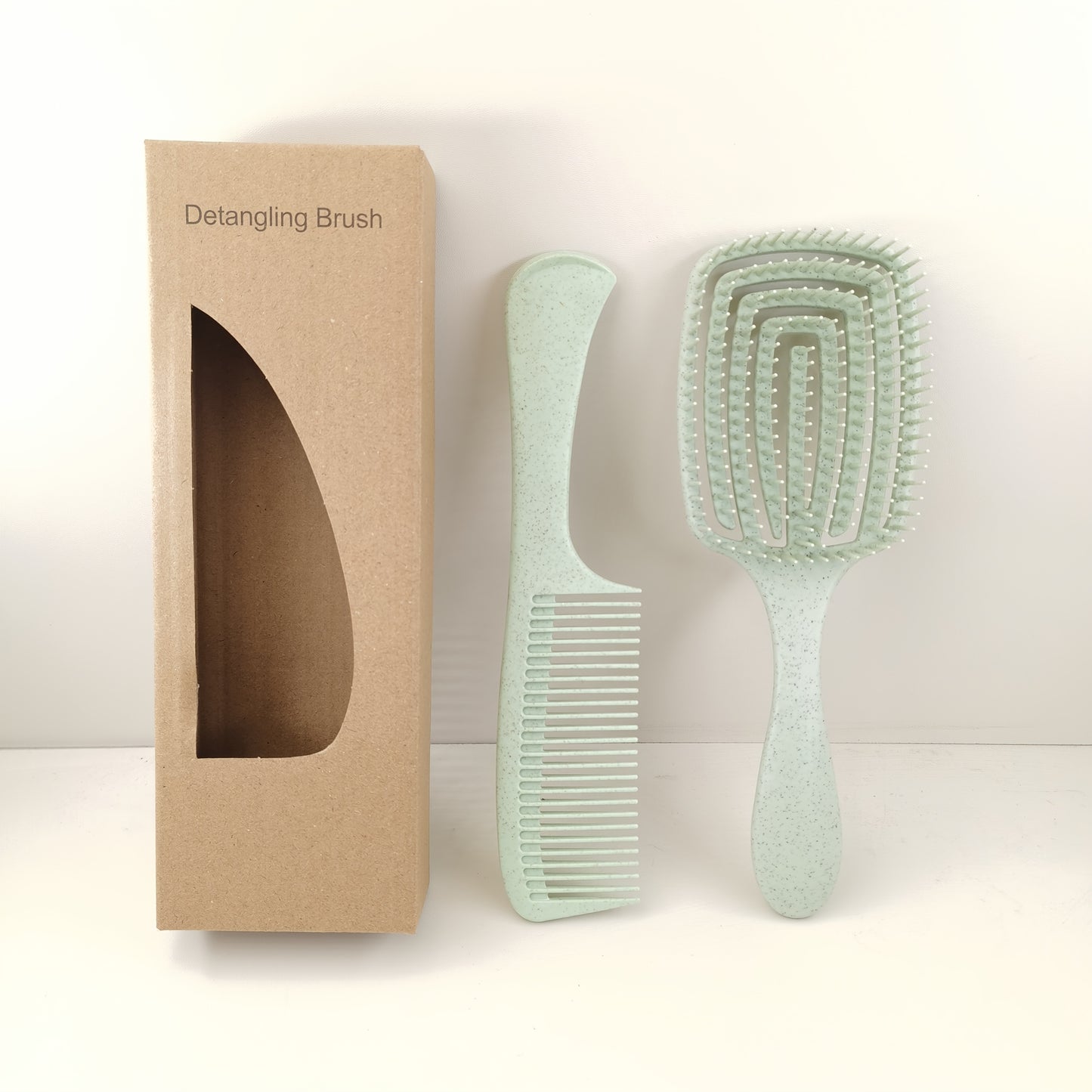 Detangling brush which comes with a large teeth comb, pressure massage hairbrush and can be used for both wet and dry hair. Made with ABS plastic handle and comes in a boxed set.