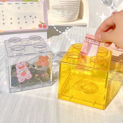 Clear plastic coin bank for saving coins at home.