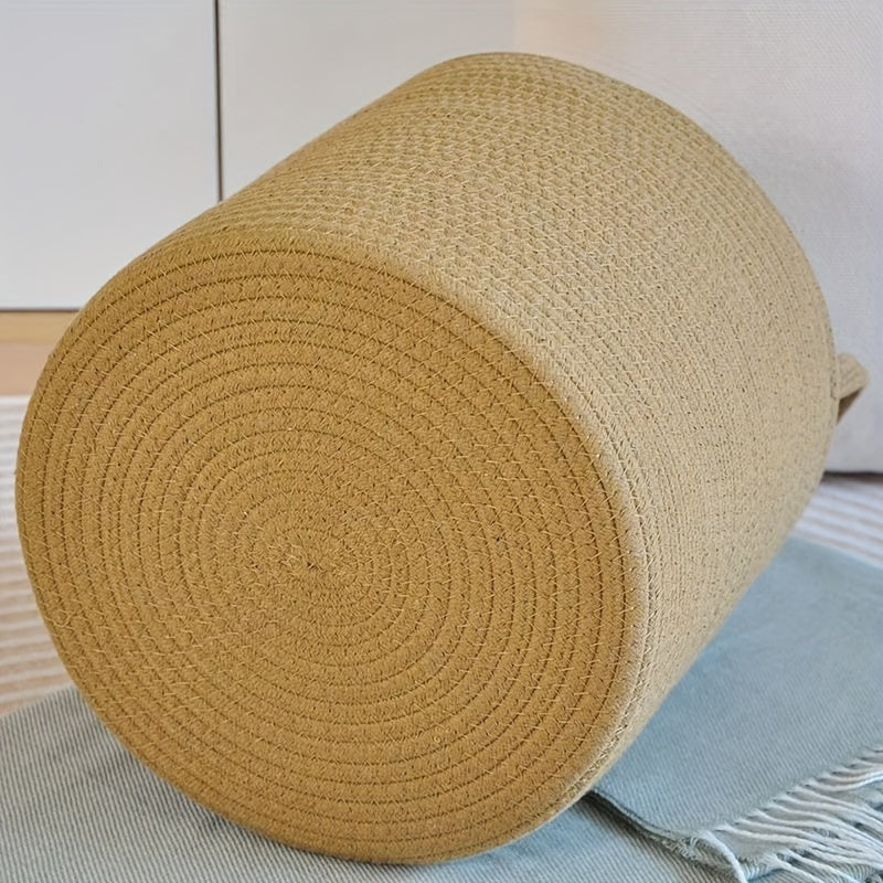 Large capacity rustic cotton rope woven laundry basket with a modern style, perfect for organizing clothes in your home. This round-shaped basket has handles for easy transportation and is ideal for use in the laundry room. No lining included.