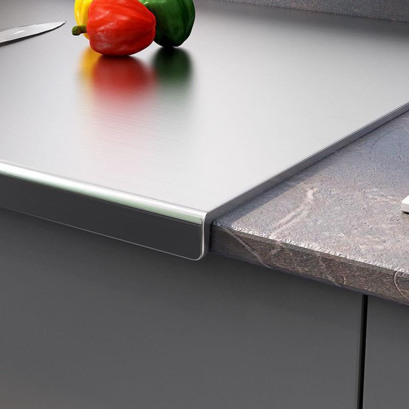 A durable stainless steel cutting board that is extra-large, double-sided, and thick for kitchen use, made of food-safe material.