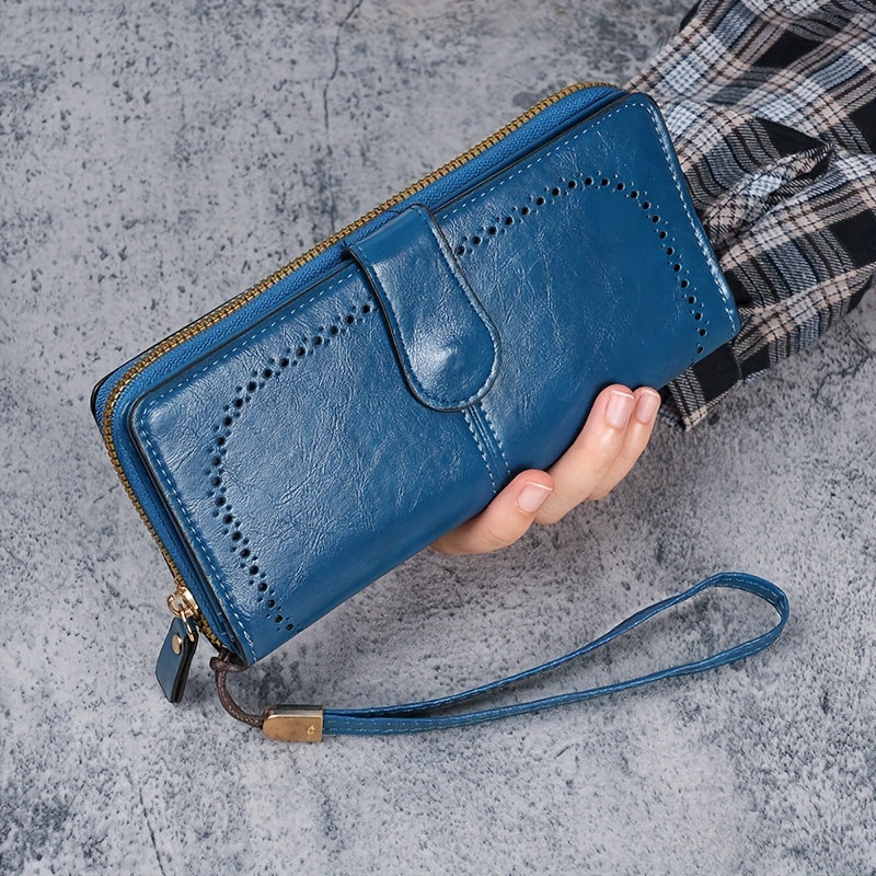 Black faux leather long clutch wallet with wristlet, ID card compartment, button closure, and edge paint. Dry clean only.