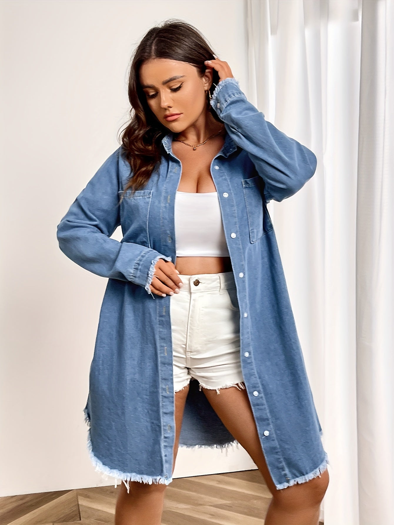 Plus size washed blue denim top with raw hem, elegant style