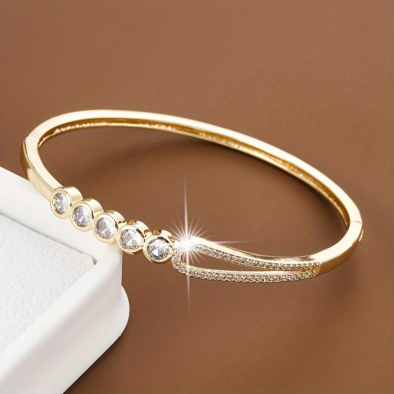 A bracelet for women featuring a circular bead ring clasp adorned with zirconia stones.