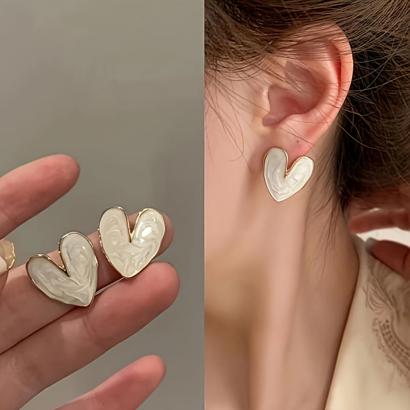 White enamel heart-shaped stud earrings with 925 sterling silver post for everyday and special occasions.