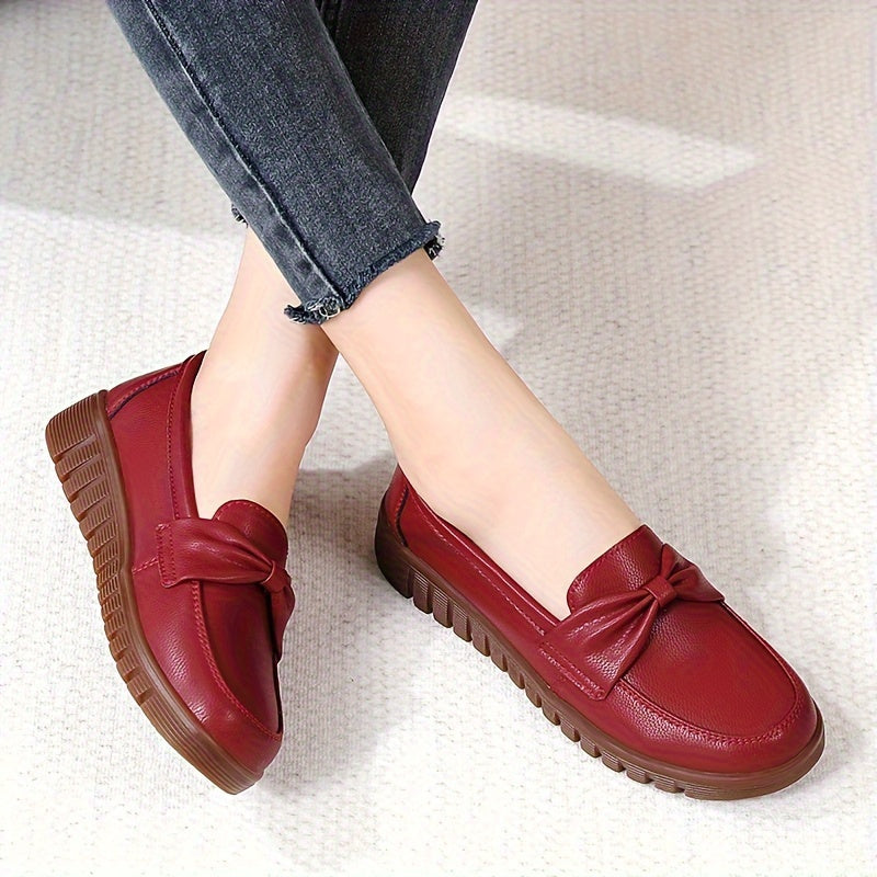 Women's comfortable penny loafers with bow embellishment, non-slip sole, round toe, all-season footwear, man-made materials, TPR sole.