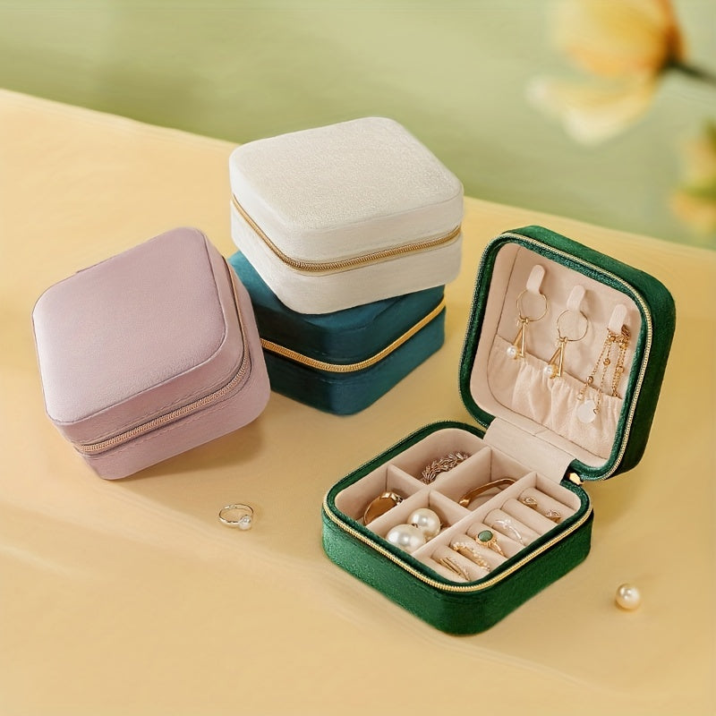 Compact travel jewelry box for women, with compartments for rings and earrings.