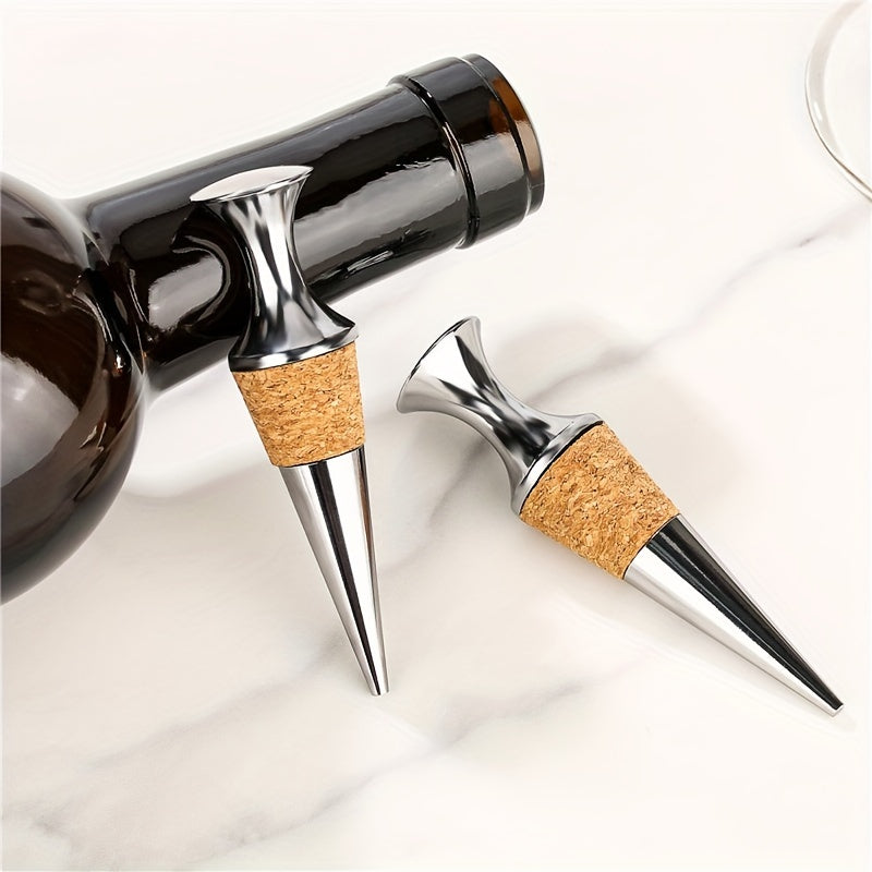 Two silver wine stoppers with wooden plugs.