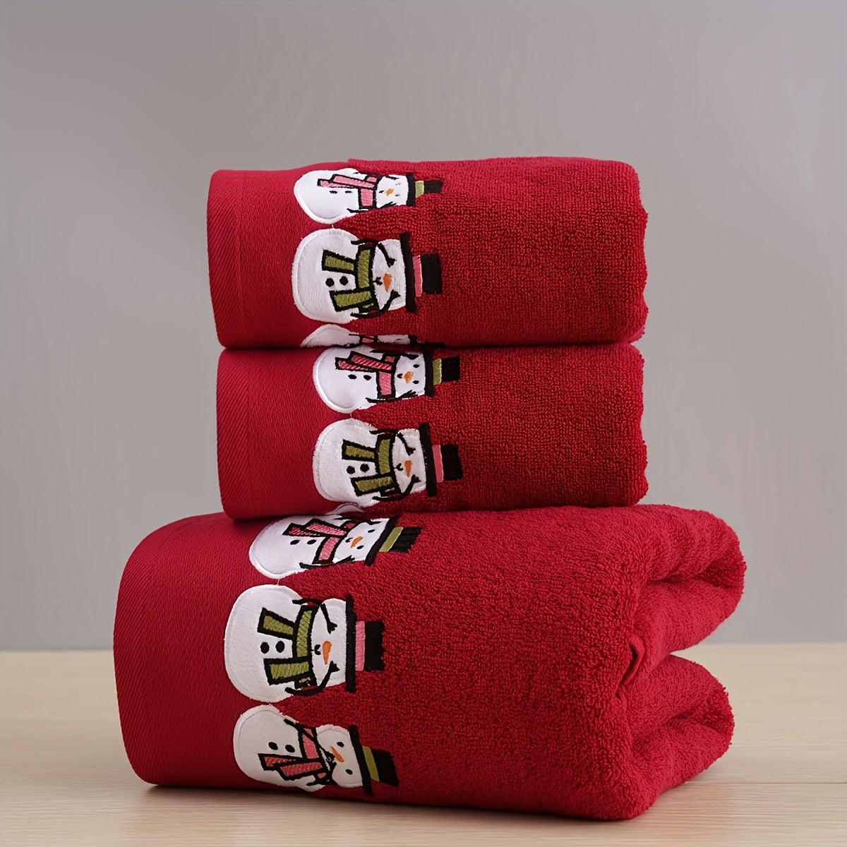 Christmas-themed towel set with embroidered snowman design. Includes 2 towels and 1 bath towel, ideal for couples' bathroom essentials and holiday gifts. Made of 100% cotton.