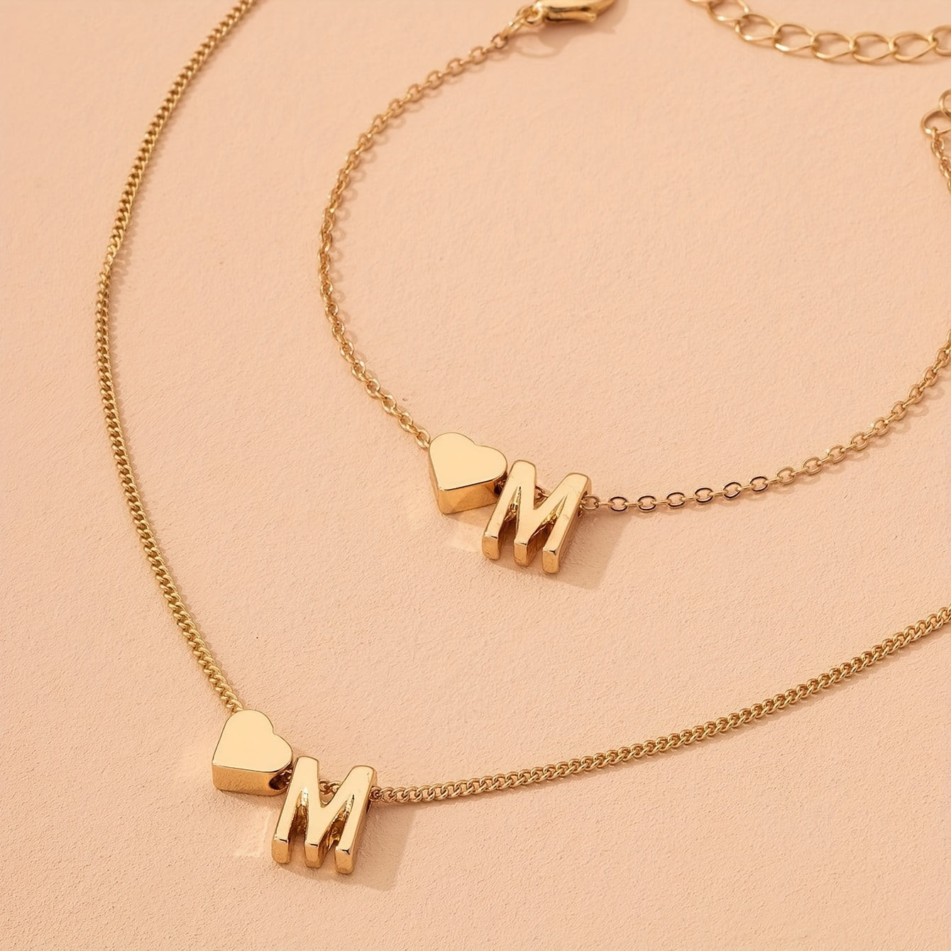 Chic two-piece set with metal heart and letter necklace and bracelet, ideal for daily wear.