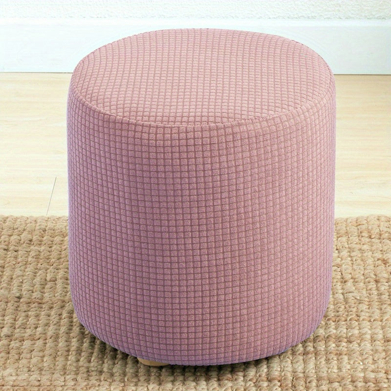 Stretchable round footstool cover made from soft polyester blend with elastic fit. Available in multiple colors, machine washable, modern design for living room ottomans.