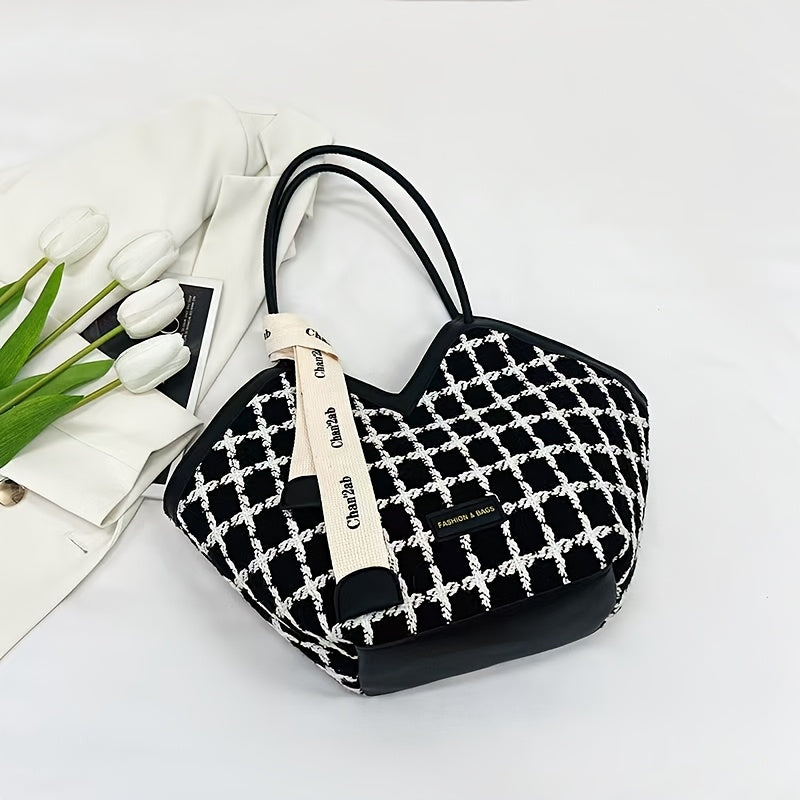 Stylish black plaid tote bag for women, spacious with zip closure and matching strap.