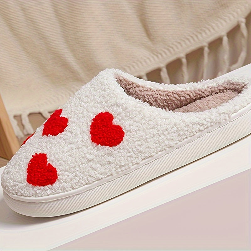 Cozy slip-on slippers with cute heart pattern, plush lining for indoor comfort.