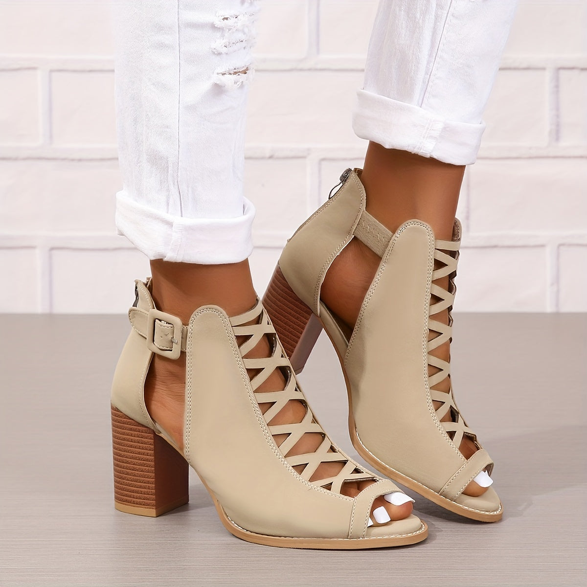 Women's brown faux leather ankle boots with elegant design including peep toe, chunky heel, crisscross straps, and buckle closure. Comfortable summer pumps with rubber sole.