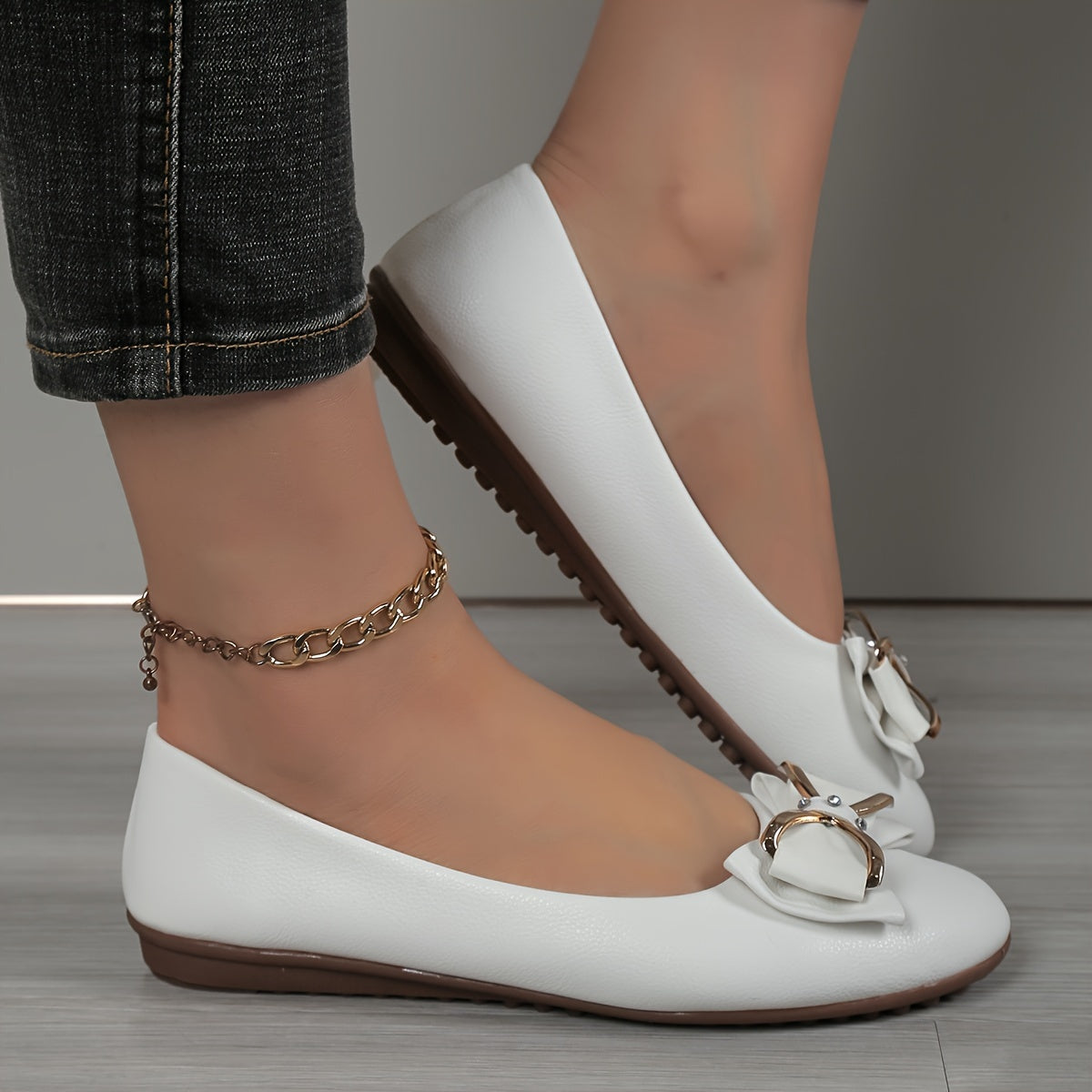 Casual flats for women with bow and rhinestone detail, round toe comfort, slip-on style, solid color.