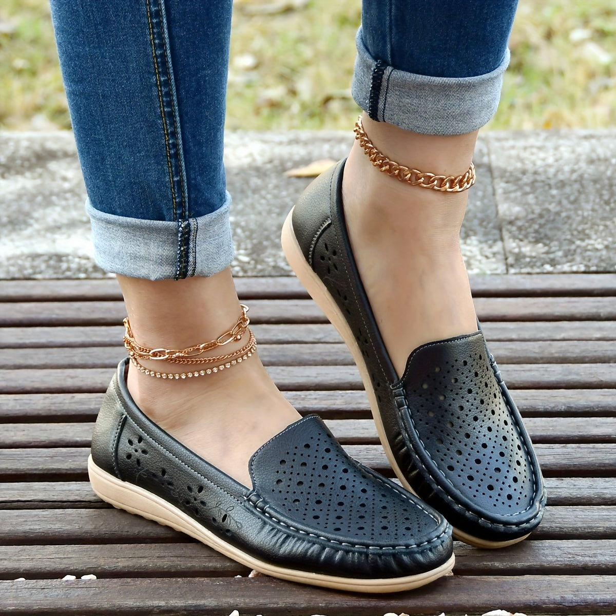 Women's white slip-on loafers with perforated design for breathability, non-slip sole, round toe, and versatile casual style for all-season wear.