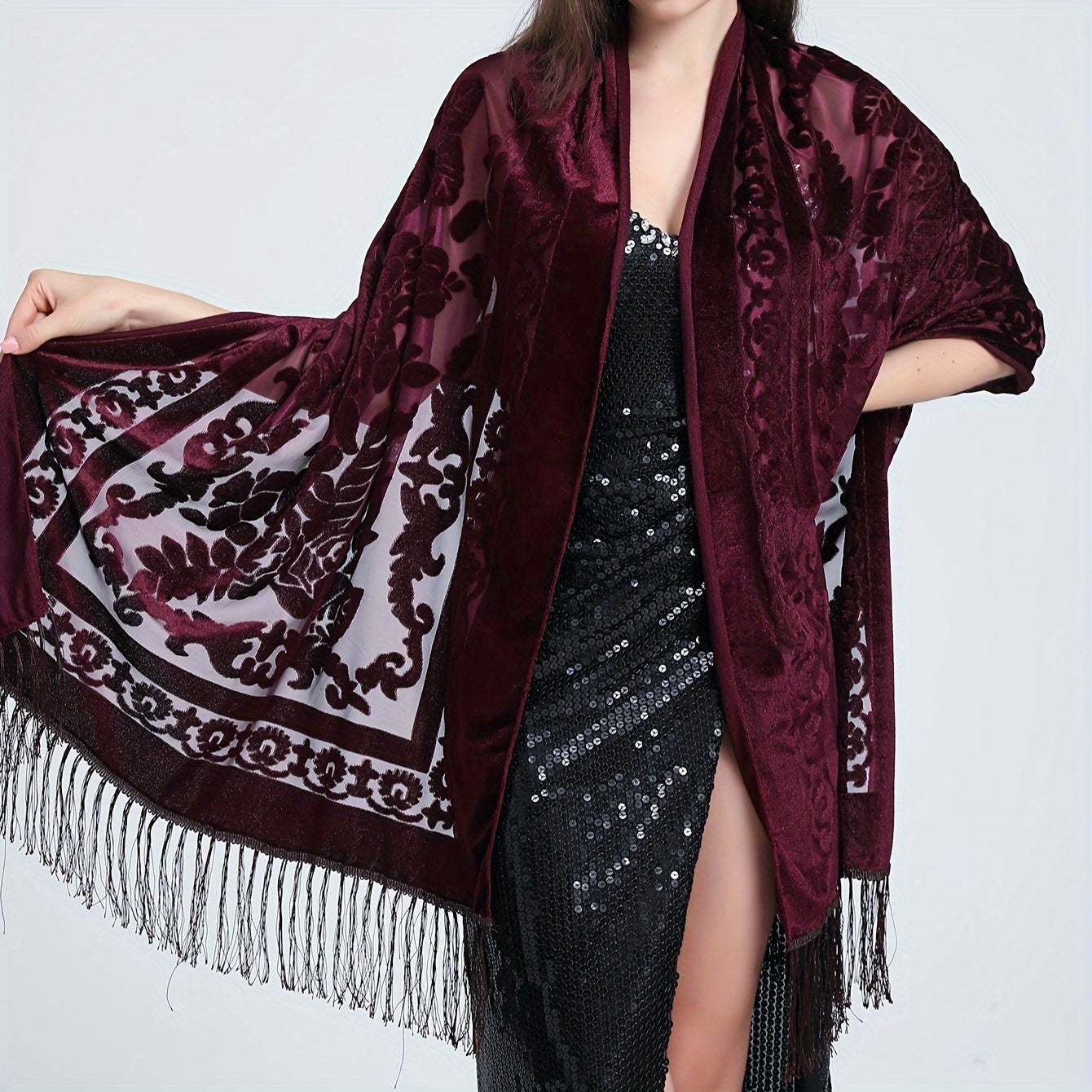 Black floral lace shawl with tassels featuring an elegant rose pattern, 3D carved design, and made of hand washable polyester. Perfect for evening events and dates.