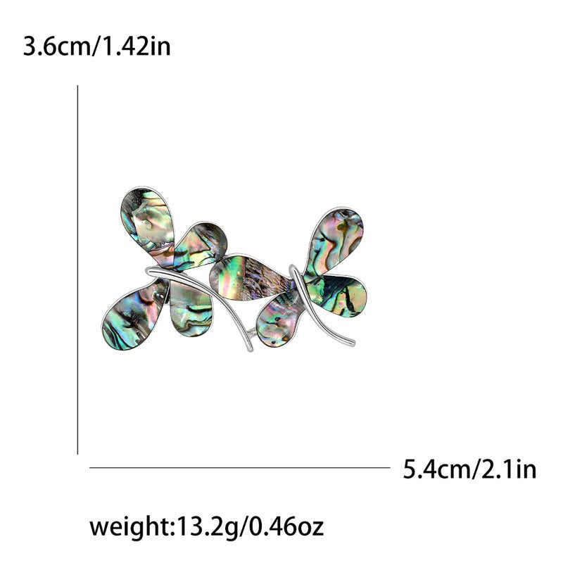 Chic and sophisticated enamel butterfly brooch pin with a unique irregular shape, crafted from high-quality silver-toned metal. A stylish and trendy fashion accessory.