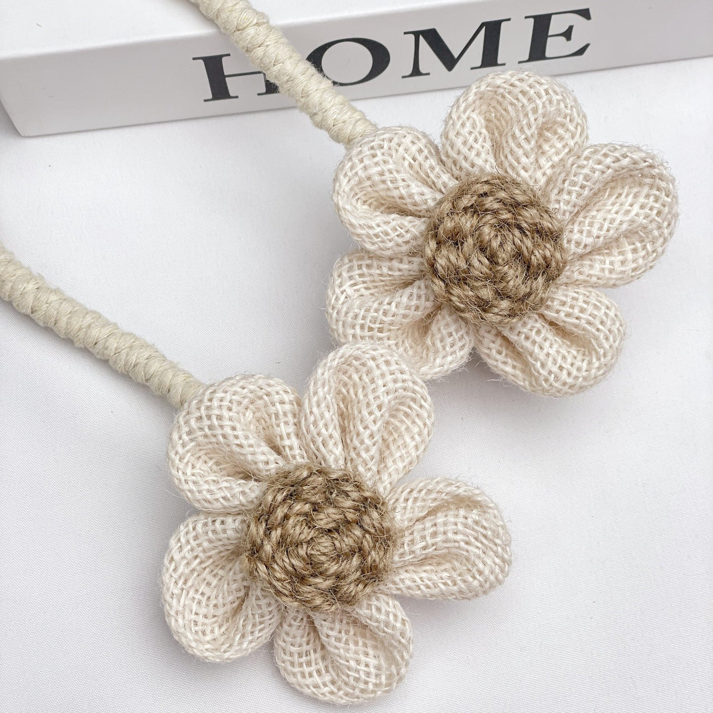 Multipack of handcrafted flower knot curtain tiebacks made from boho style cotton and linen - perfect decorative holdback clips for living room, bedroom, and home decor.