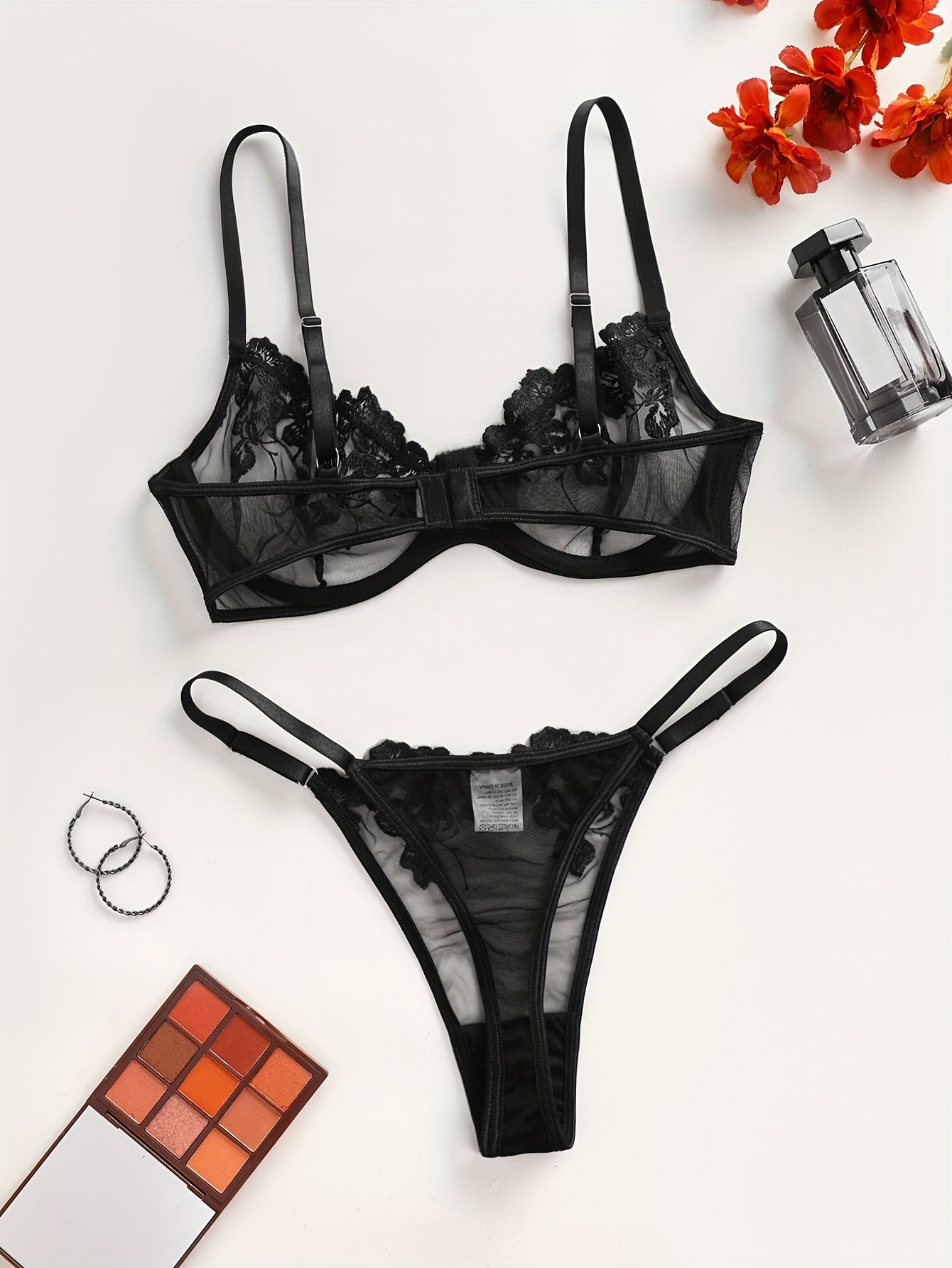 Sheer floral embroidered lingerie set with a low waist thong for women.