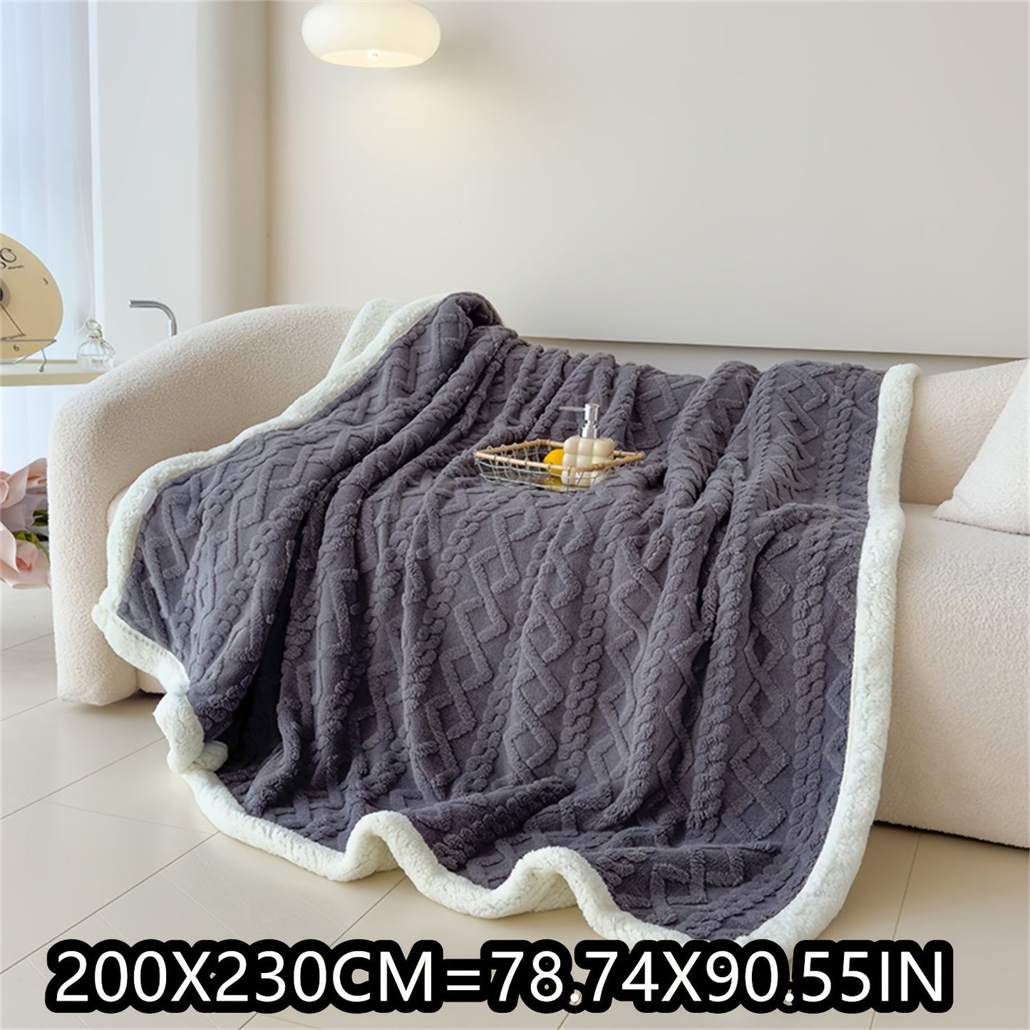 Soft cable-knit fleece blanket in blue, available in 150x200cm or 200x230cm sizes. Featuring a contemporary style, this blanket is machine washable and perfect for use in the bedroom, living room, office, or while camping during the winter. Made with a