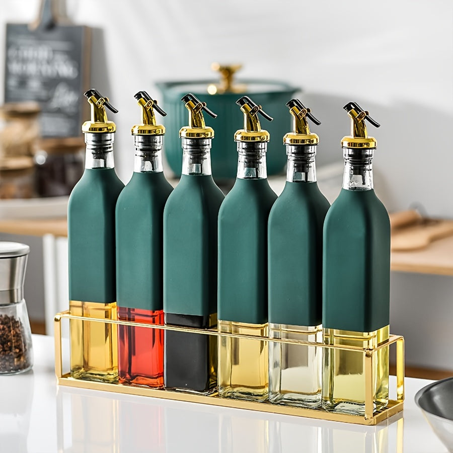 Set of glass dispenser bottles for olive oil and vinegar with a golden pour spout. Hand wash only, PVC free. Includes 6 rectangular cruets with a storage holder rack.