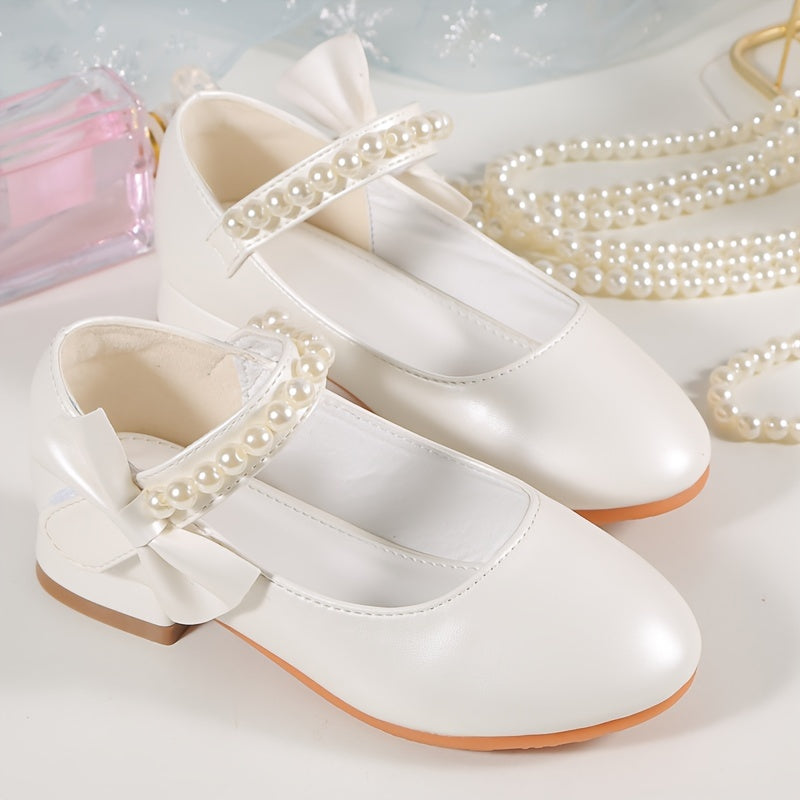 Princess high heels for girls with pearl accents and bowknot. Breathable and non-slip, perfect for school, parties, and formal events. White synthetic material with chunky heel and round