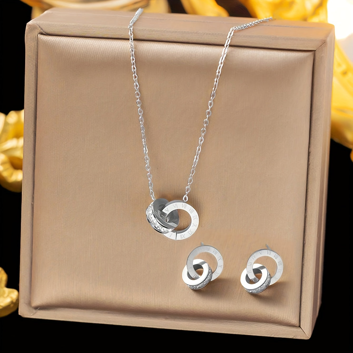 This elegant stainless steel necklace and earrings set features a stylish double-loop Roman numeral engraving. Perfect for daily wear, special occasions, or as a thoughtful gift for a lady. Set includes three pieces.