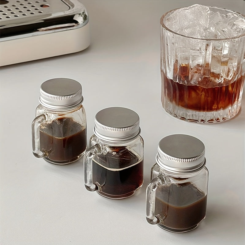 Mini Mason jar shot glass with lid, leakproof glass, ideal for home, parties, and bars. Perfect for beverages such as coffee, milk, juice, honey, and jam. Hand wash only.