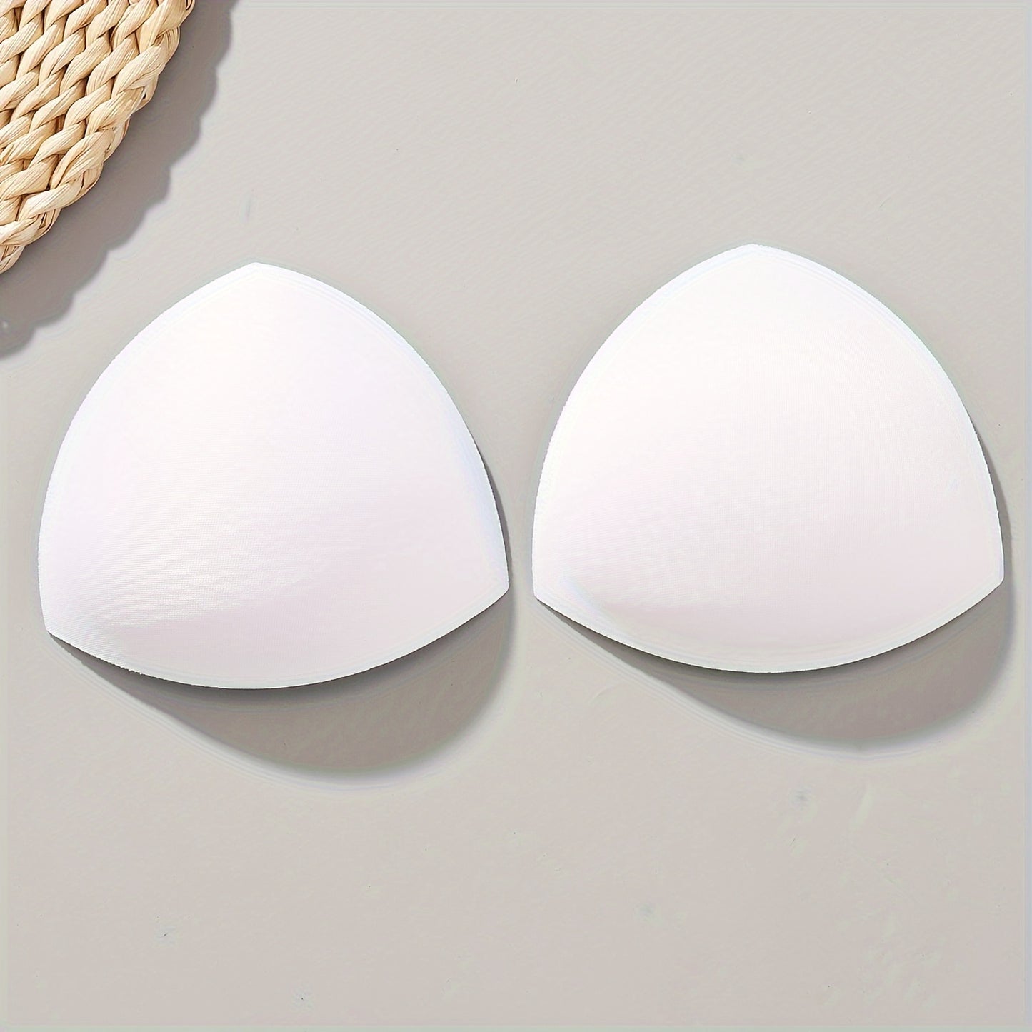 Women's triangle bra pads enhance and lift with push-up and adjustable features. Available in black, white, and nude colors.