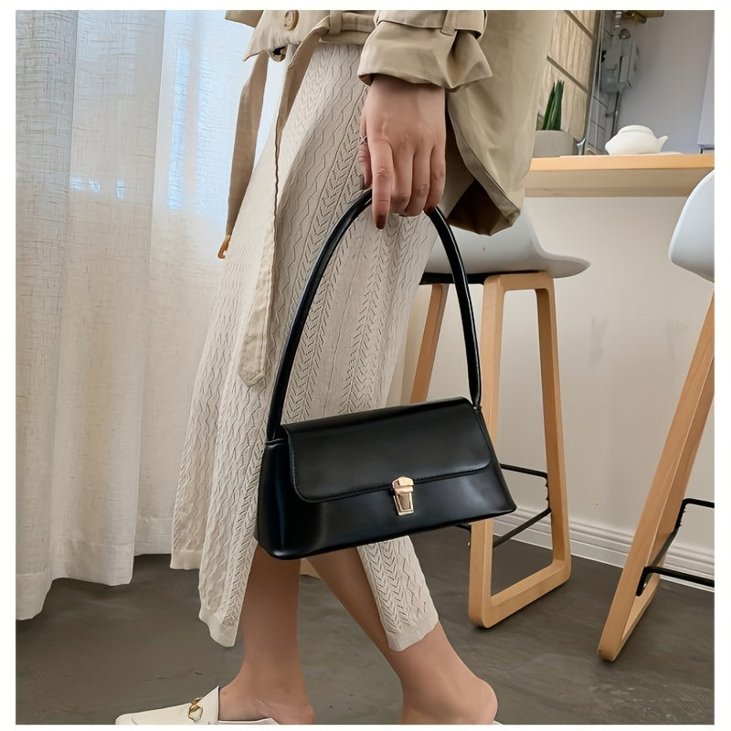 Chic black shoulder bag for women with French-inspired design and golden clasp. Versatile and stylish for everyday use with neat stitching detail.