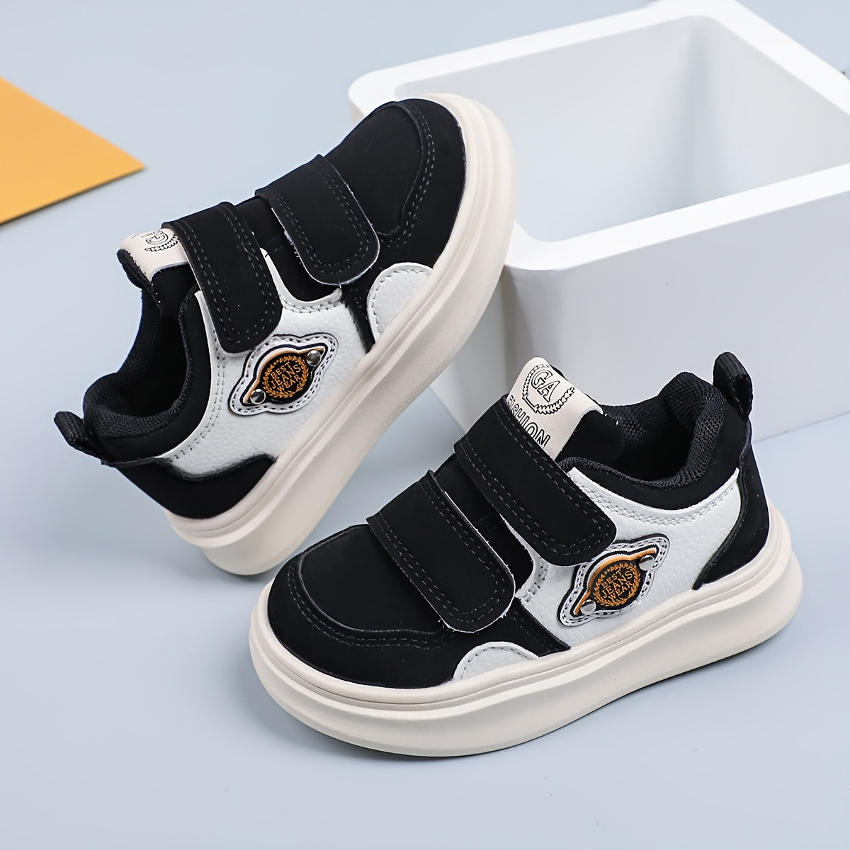 Casual low top sneakers for boys and girls with hook & loop closure, breathable faux upper, rubber sole, fabric insole, and round toe design.