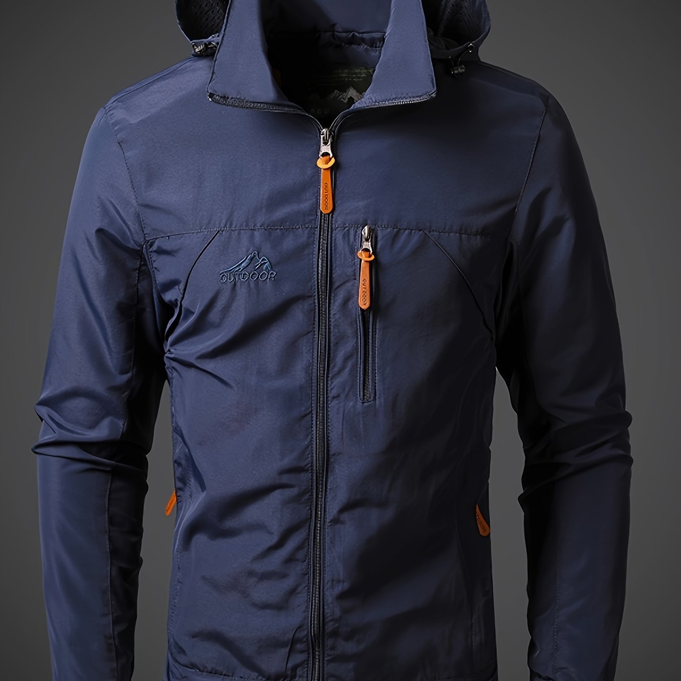 Men's lightweight hooded polyamide jacket with zipper closure and polyester lining, ideal for hiking and outdoor activities in the spring/fall season.