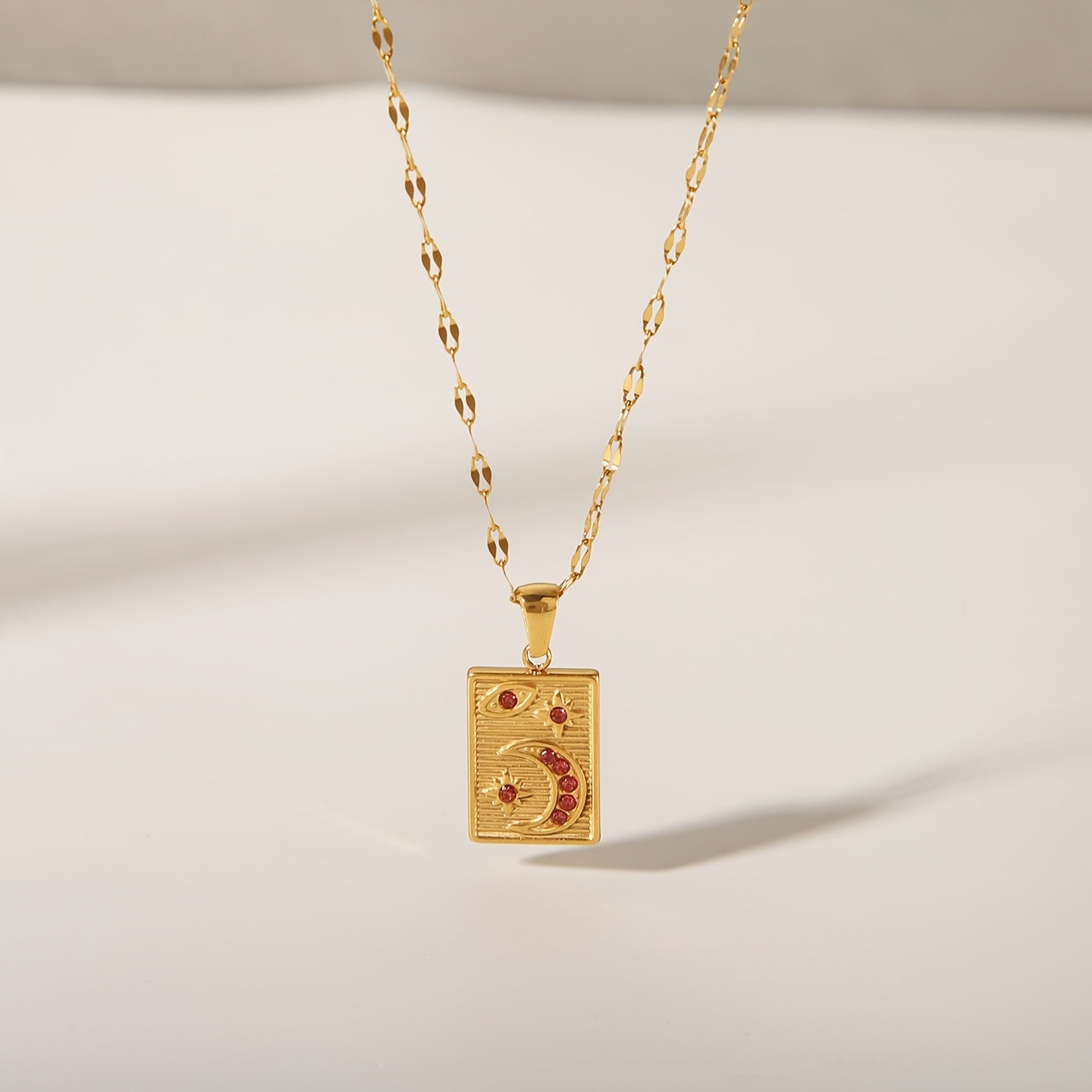 18K Golden Plated Stainless Steel Pendant Necklace featuring a Minimalistic Geometric Rectangle & Crescent Moon Design adorned with Red Synthetic Zirconia Stones, a Stylish and Versatile Piece of Fashion Jewelry perfect for Women to Wear on Both Daily