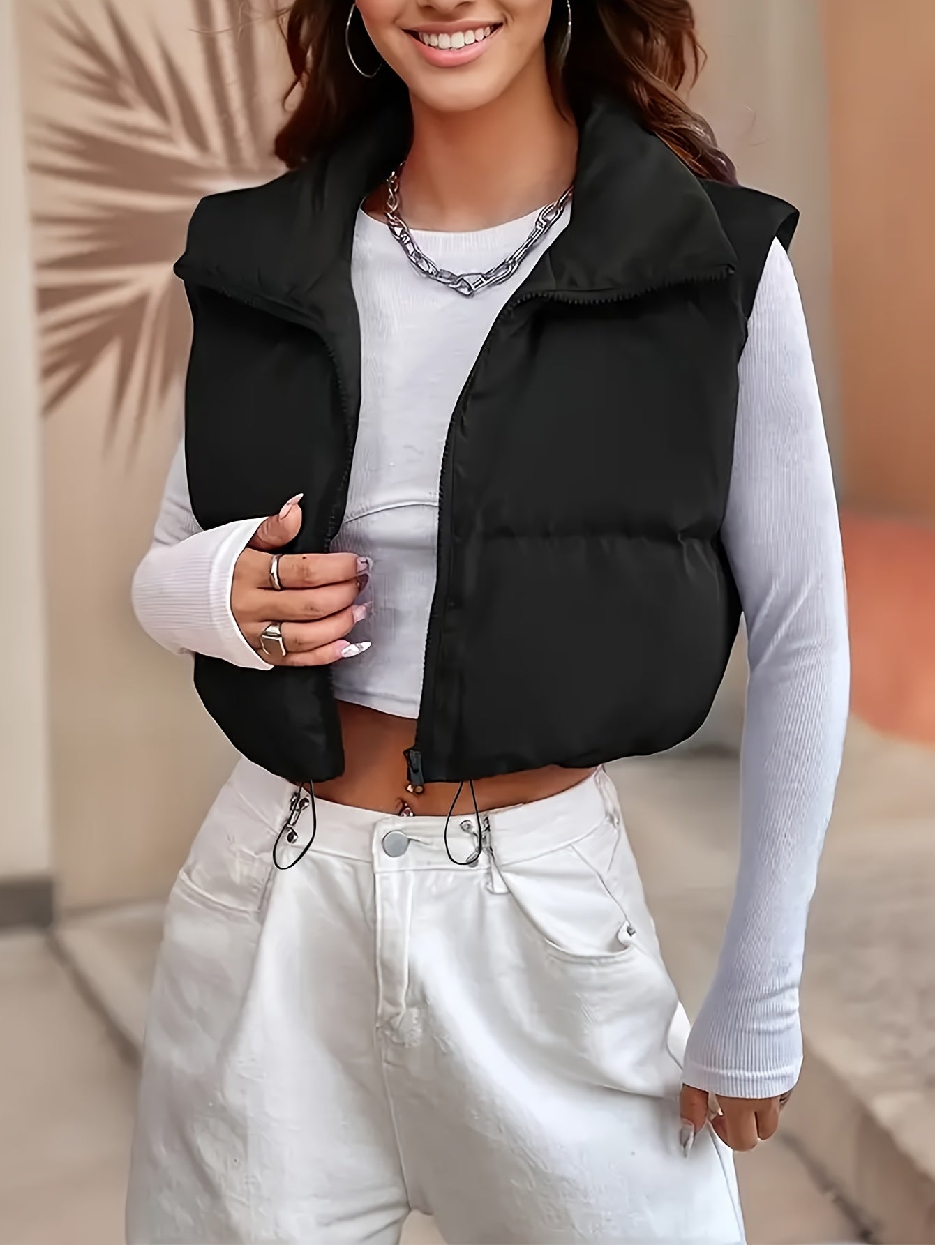 Casual high neck padded vest with drawstring for women, made of solid color polyester blend for fall/winter season.