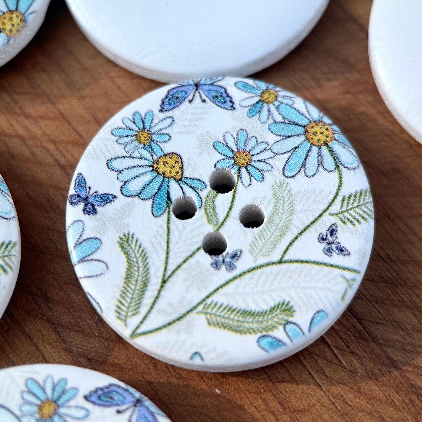 A set of 10 large decorative flower and butterfly buttons made of natural wood, each measuring 30mm in size and featuring 4 holes for sewing.