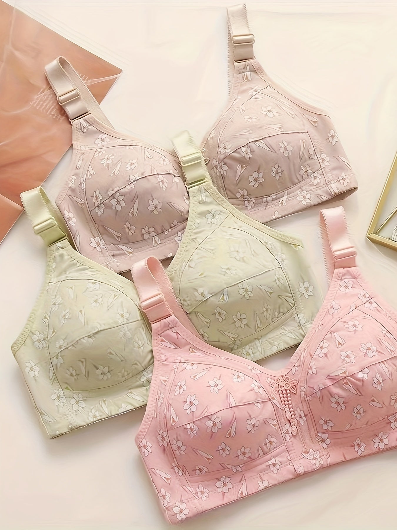 Set of 3 elegant floral applique wireless bras with high support push-up design and comfortable breathable fabric for adults.