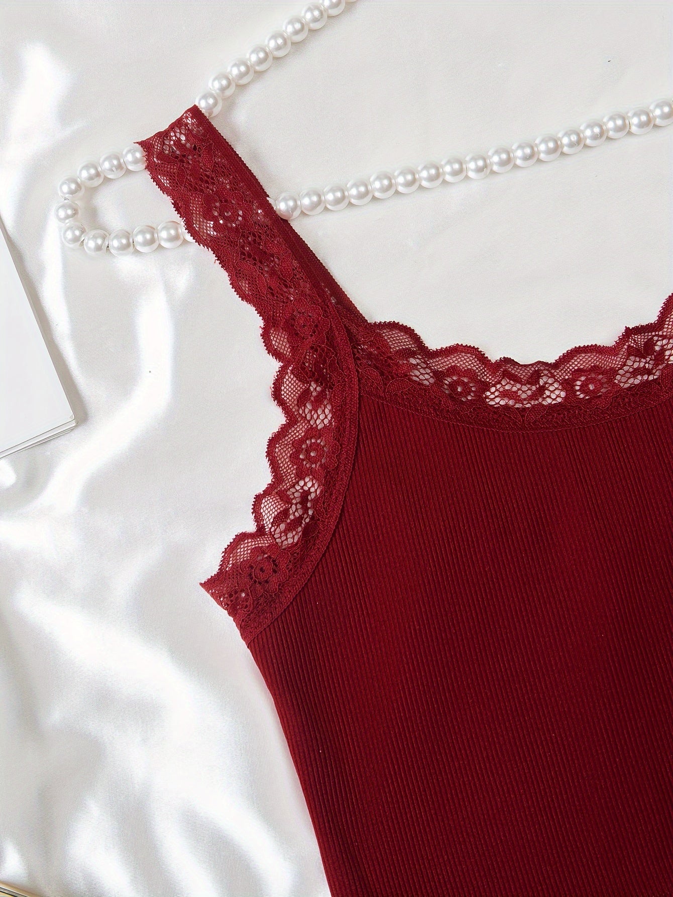 Women's loungewear set includes lace trim cami top and elastic waistband shorts.