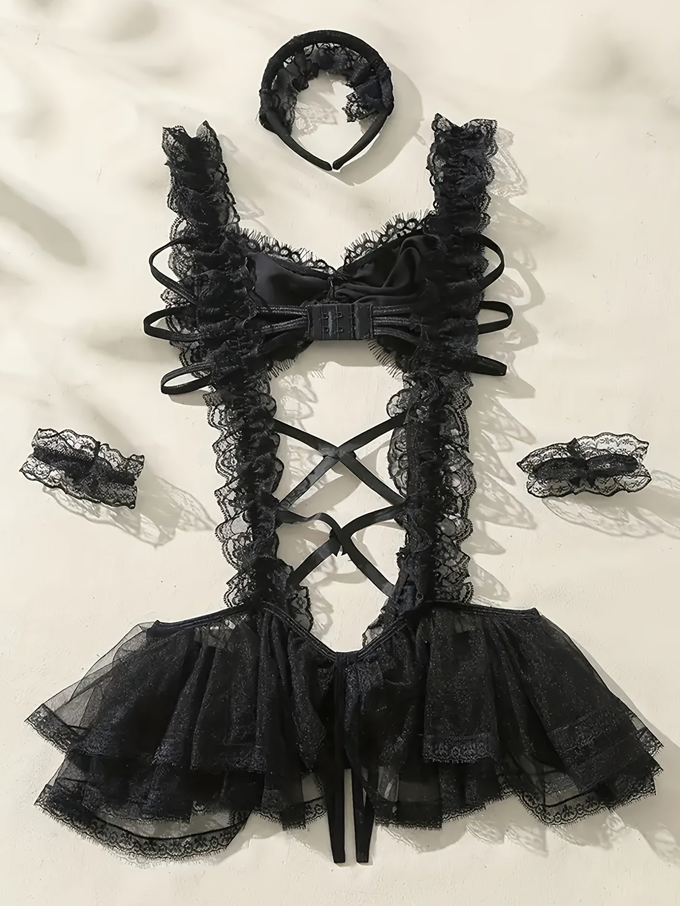 Sexy maid costume with mesh tights, suspender skirt, headwear, and bracelet.