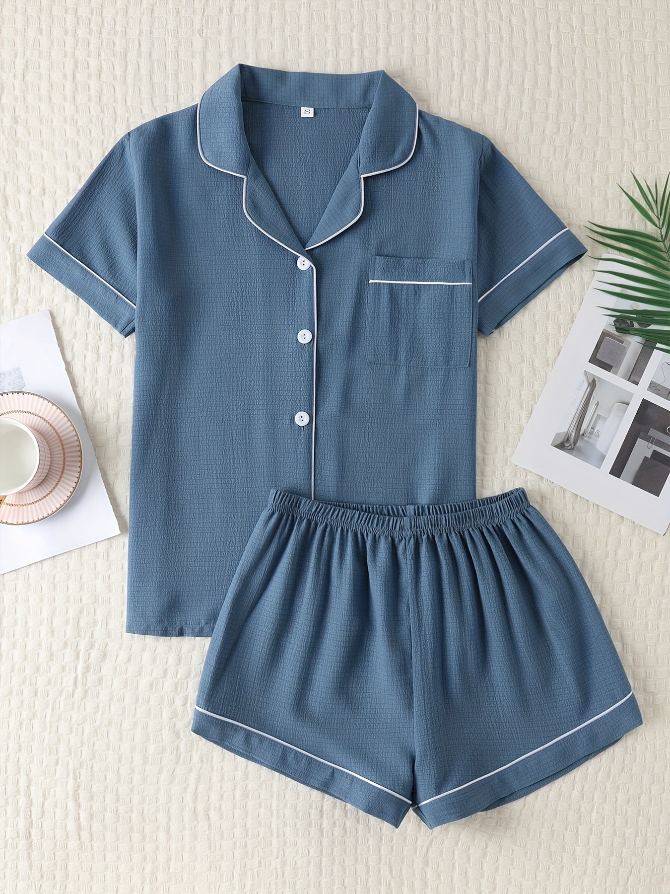 Basic pajama set for women, featuring a short-sleeve button-up top with lapel collar and elastic shorts.